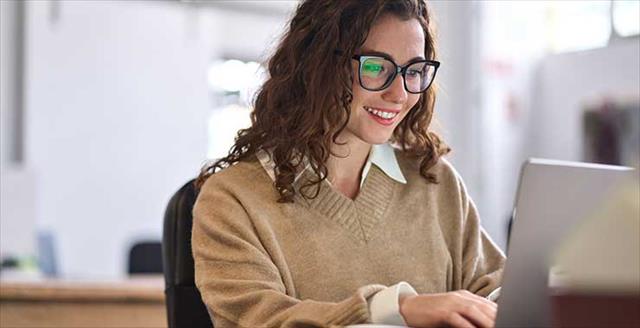 young female researcher looking at laptop computer