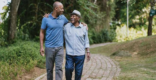 two men walking in a park