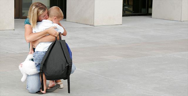 mother hugging son and saying goodbye