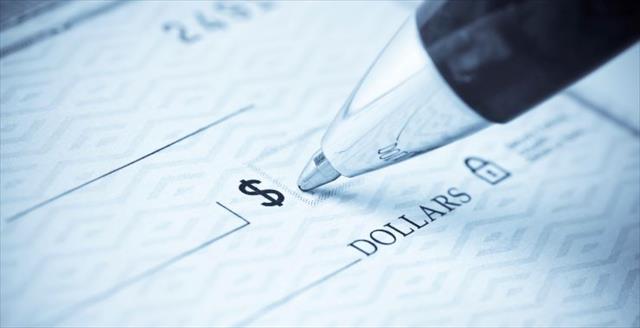 Blank check with pen hovering above
