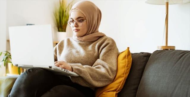 Young professional checking email on a laptop