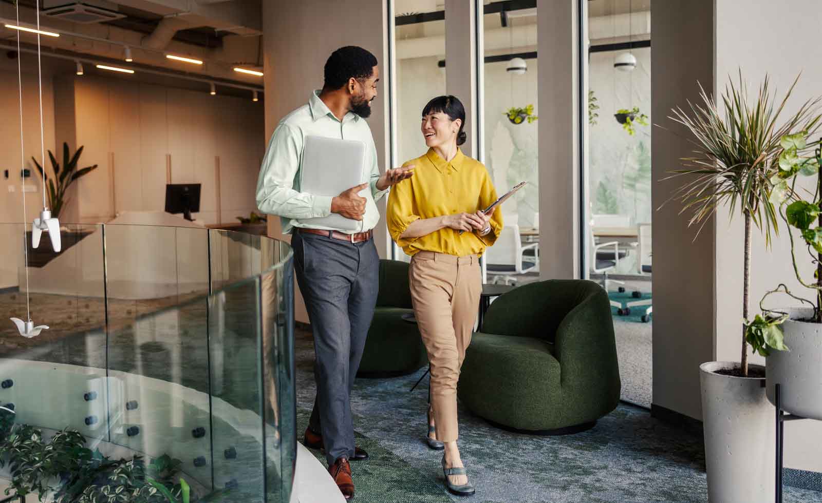 business colleagues talking while walking in office building