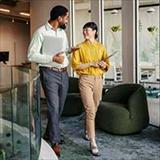 business colleagues talking while walking in office building