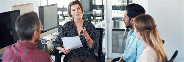 woman in conversation with colleagues