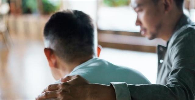 A man embracing and forgiving his friend.