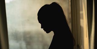 silhouette of woman in front of window