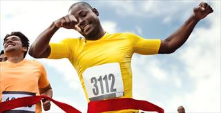 man at the finish line of a marathon