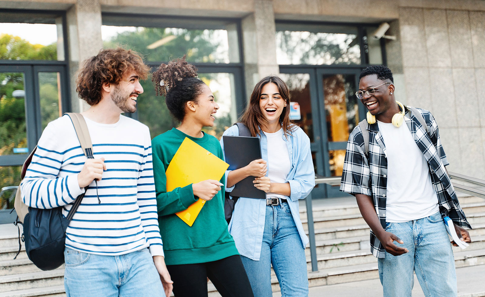 Diverse group of graduate students walking on campus.