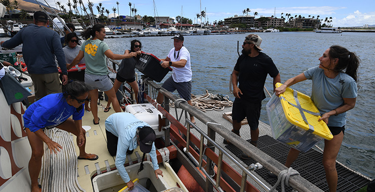 Members of the Hikianalia canoe club off load a boat with supplies at the Maalaea Harbor before heading into the burn area on Monday August 14, 2023 in Maalaea, Hawaii.