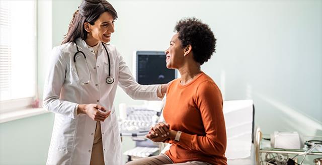 medical practitioner reassuring a patient