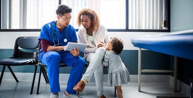 Woman with toddler talking to physician