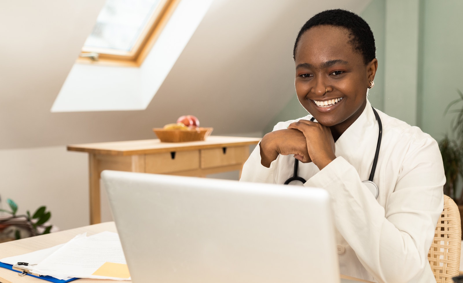 Black female doctor working on online medical records