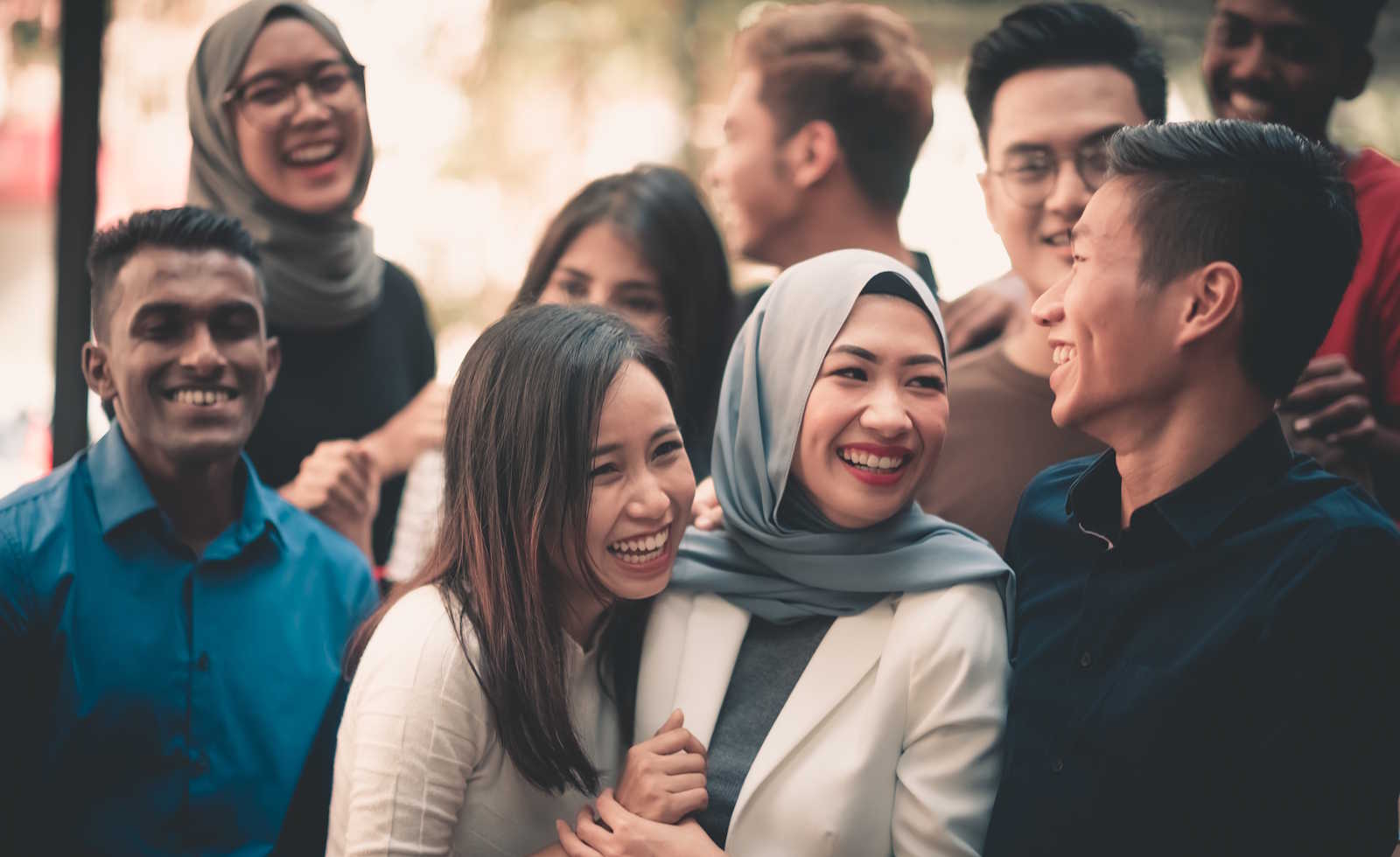 A group of young and diverse adults gathering 