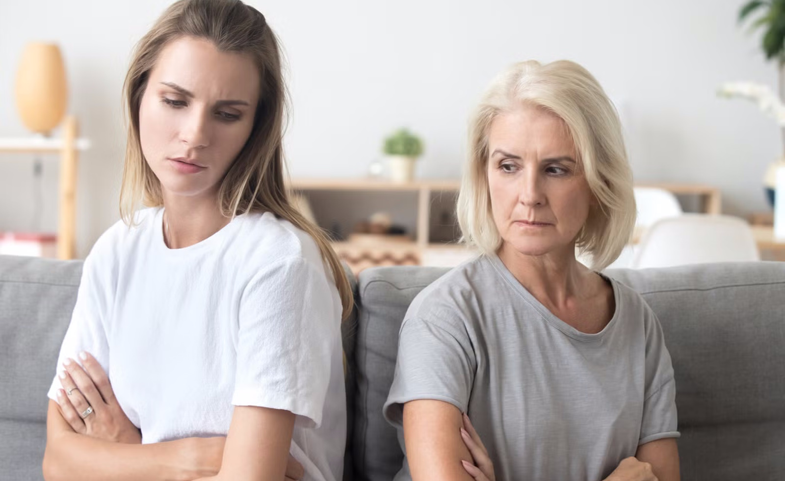 Daughter and mother with arms crossed