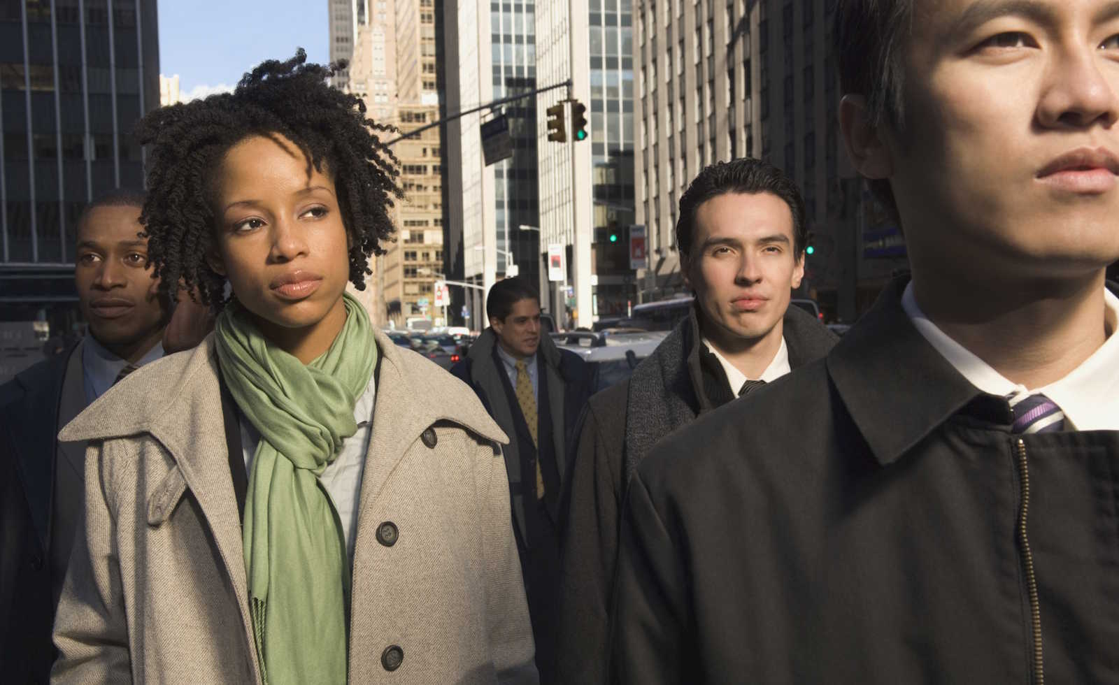 Multi-ethnic businesspeople in urban scene