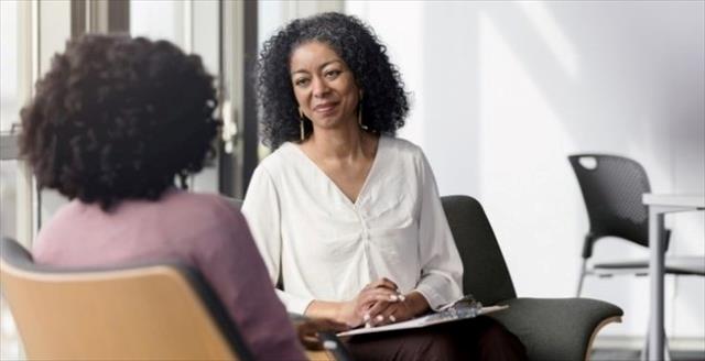 Psychologist speaks with patient