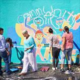 Group of people drawing on a wall
