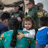 Toddler girl being carried by mother