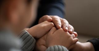 woman and child holding hands
