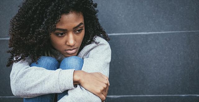 young Black woman looking sad