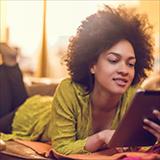 African American woman reading something from e-reader