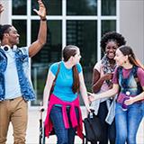Young girl using crutches walks alongside diverse group of friends.