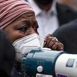 Woman in mask with bullhorn