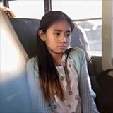 On school bus, young girl is sad