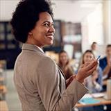 Young teacher pointing at presentation during class.