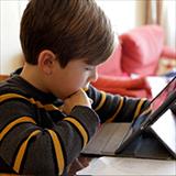 Young male student looking computer screen