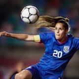 female soccer player focusing on the ball