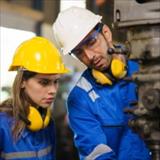 female and male mechanical technicians fixing a machine