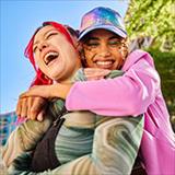 Two young women laughing together.