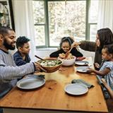 A family gathered around the dinner table, sharing a meal