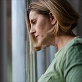 Middle-aged woman gazing out the window