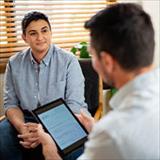 Mental health professional meeting with a patient during a counseling session in an office.