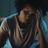 Man sitting up in bed at night