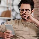 A man holding and looking at his smartphone