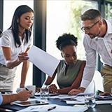 Diverse group of young professionals exchange ideas in the boardroom.