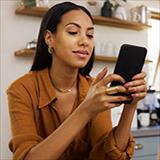 Young businesswoman looking at smartphone.