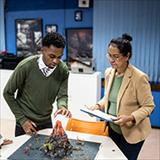 Student presenting science project in classroom