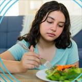 young woman not interested in eating her meal