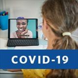 Young girl looking at teacher on computer screen