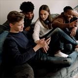 group of teens looking at smartphones