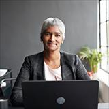 Woman in front of computer smiling