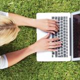 woman typing on laptop computer outside