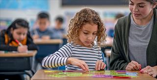 elementary school girl focused and thinking about task