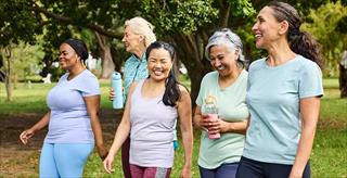 diverse group of women walking in a park