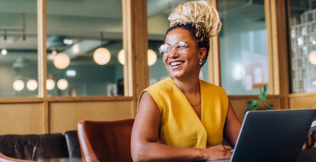 Happy professional woman employee using computer for work