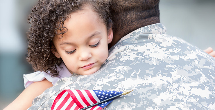 Soldier hugging daughter upon homecoming